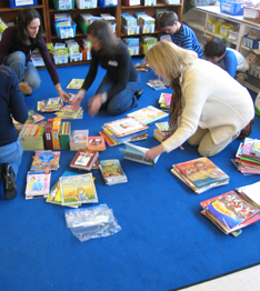 Staff members sorting books on the floor